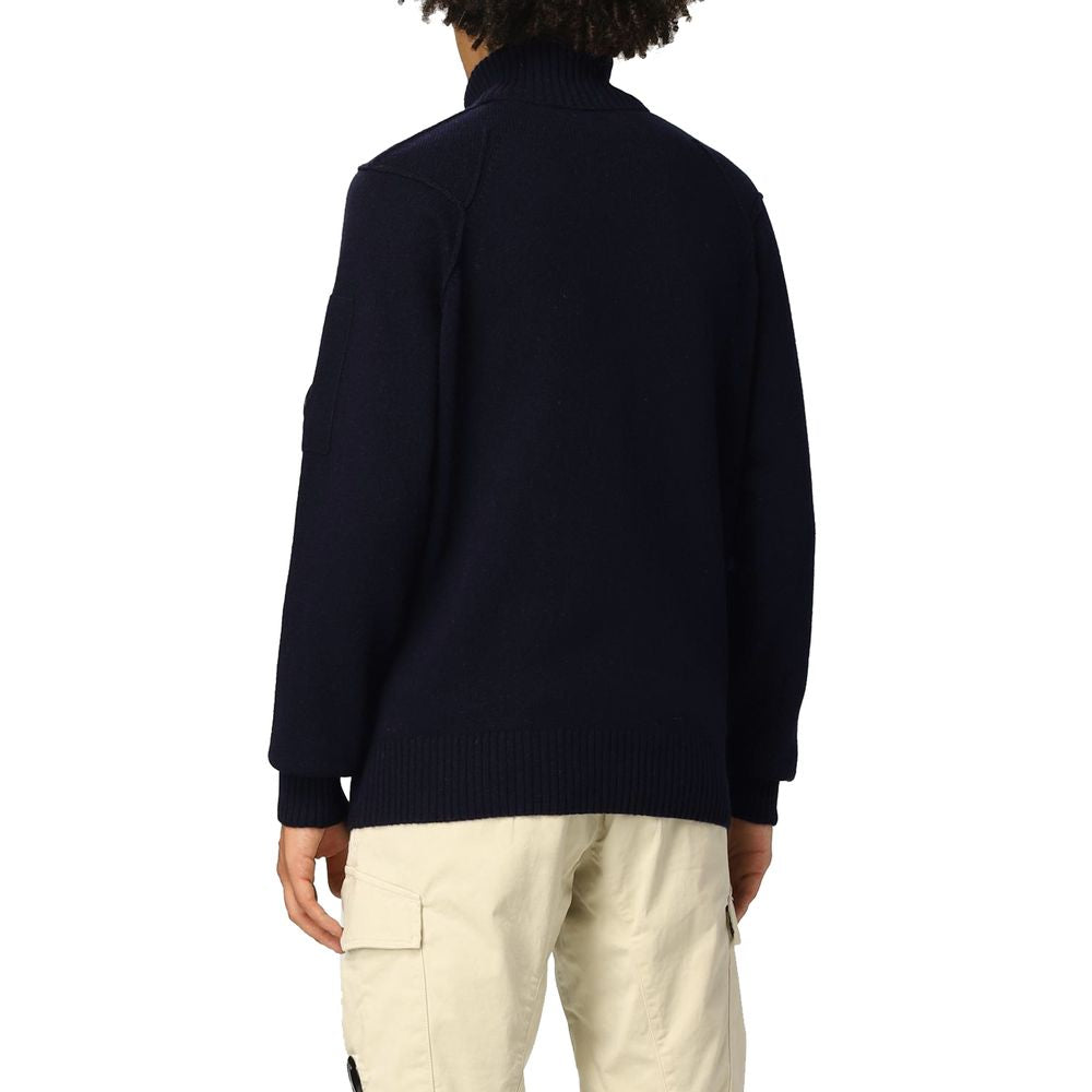 Back view of C.P. Company Blue Wool Sweater with ribbed turtleneck collar, featuring logo plaque on shoulder, worn by model.
