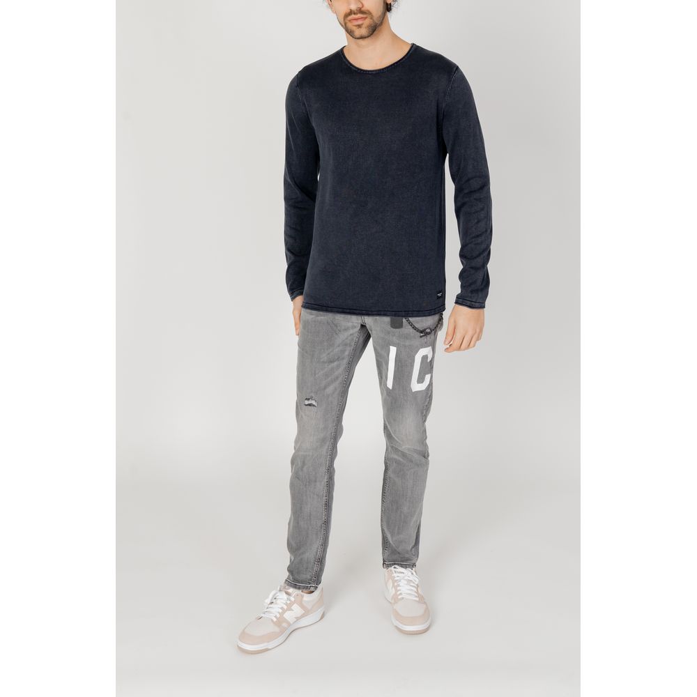 Model wearing Jack Jones Blue Cotton Sweatshirt with casual gray pants and sneakers, showcasing a casual refined look.