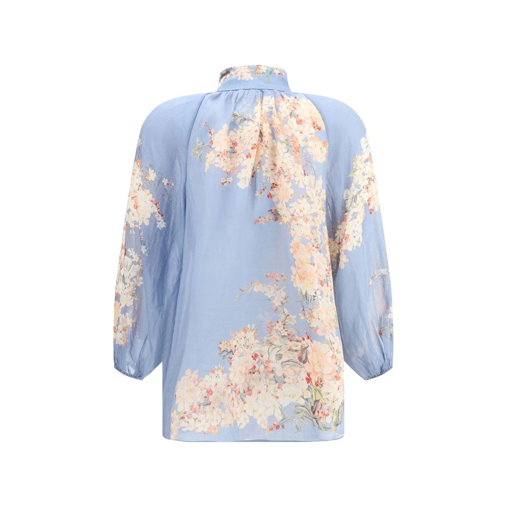 Zimmermann Light Blue Ramie Blouse with floral print and puff sleeves, featuring elastic cuffs and refined lace neck detailing.