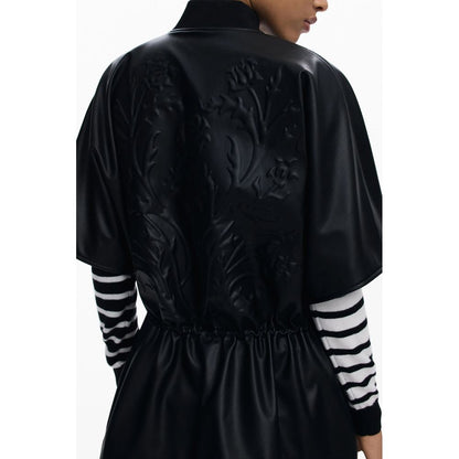 Back view of Desigual Black Polyethylene Women Poncho with embossed print and drawstring waist for a confident and stylish look.