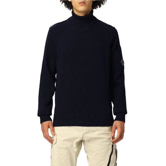 C.P. Company Blue Wool Sweater with ribbed turtleneck and logo plaque, modeled by person in beige pants
