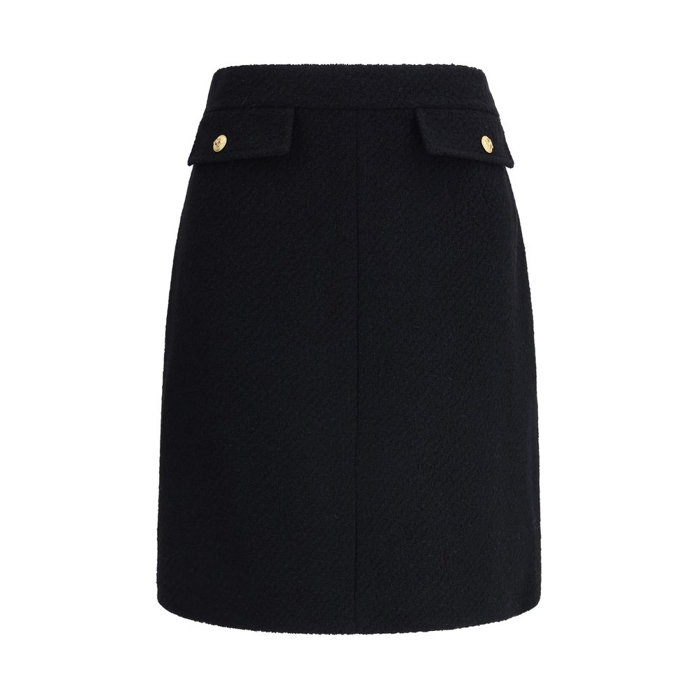 Chloé Black Wool Midi Skirt featuring front flap pockets with gold-tone buttons, crafted from premium bouclé wool for a sleek look.