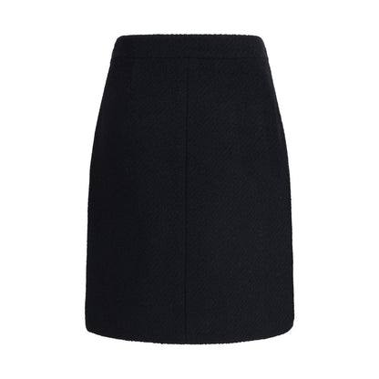 Chloé Black Wool Midi Skirt with bouclé texture, knee-length design, front flap pockets with gold buttons, and side zip fastening, AW25.