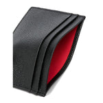 Black Christian Louboutin Mooncrest leather card case with embossed logo and multiple slots, featuring grained calf leather texture.