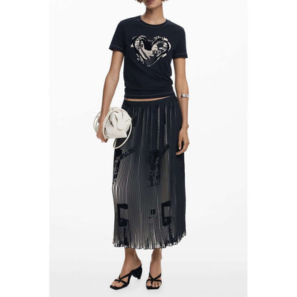 Desigual Black Polyester Women Skirt with pleated design and newspaper motifs, worn with a casual black top and accessories.