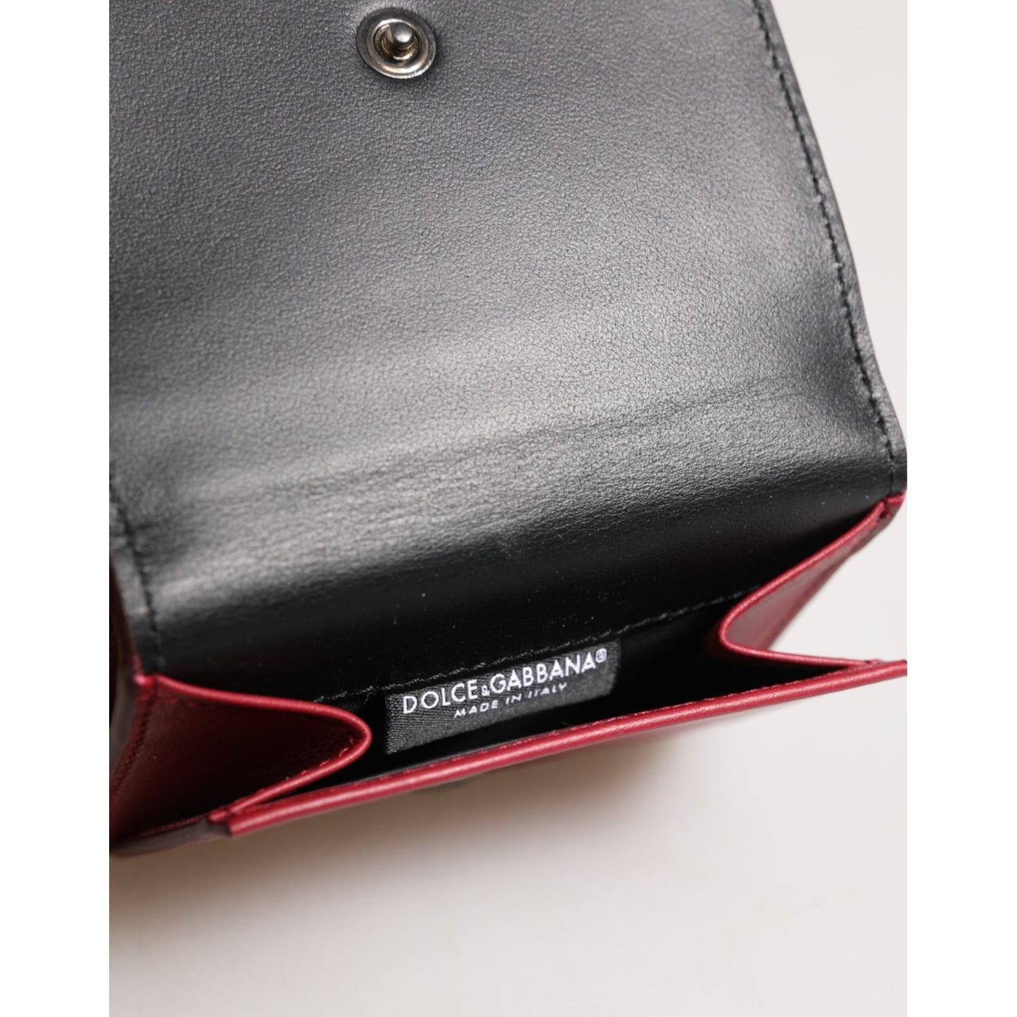 Open Dolce & Gabbana Red Leather Bold Logo Print Trifold Men Card Holder Wallet showing brand label and interior details.