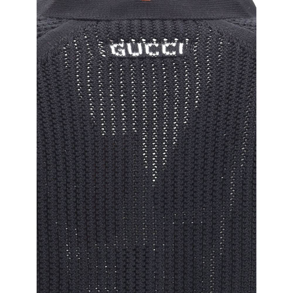 Close-up of Gucci Black Cotton Cardigan knit weave texture, showcasing elegant detail and logo on neck, perfect for a refined look.