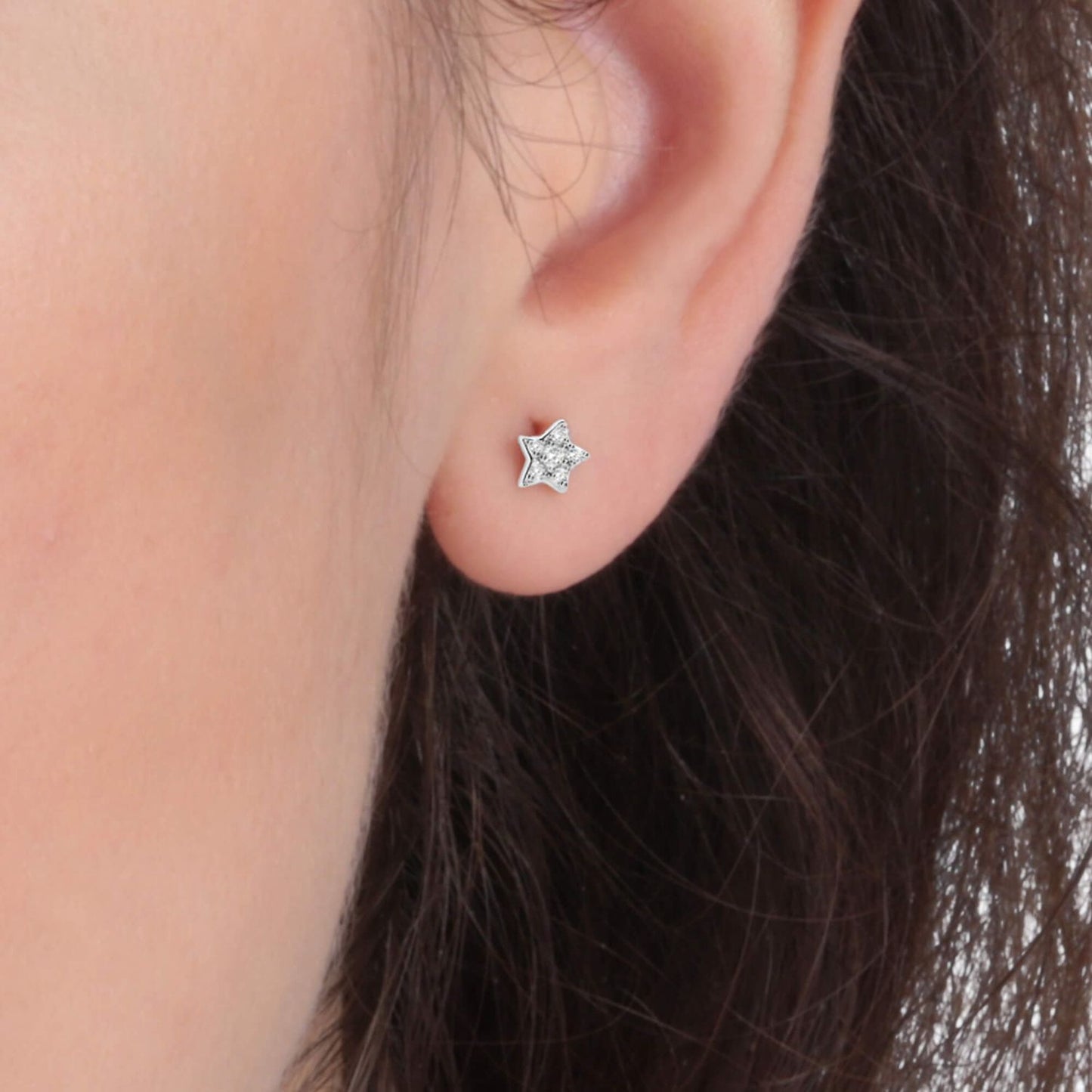 Silver stud earring in star shape by LA PETITE STORY JEWELRY Mod. LPS02ARQ03, worn on woman's ear