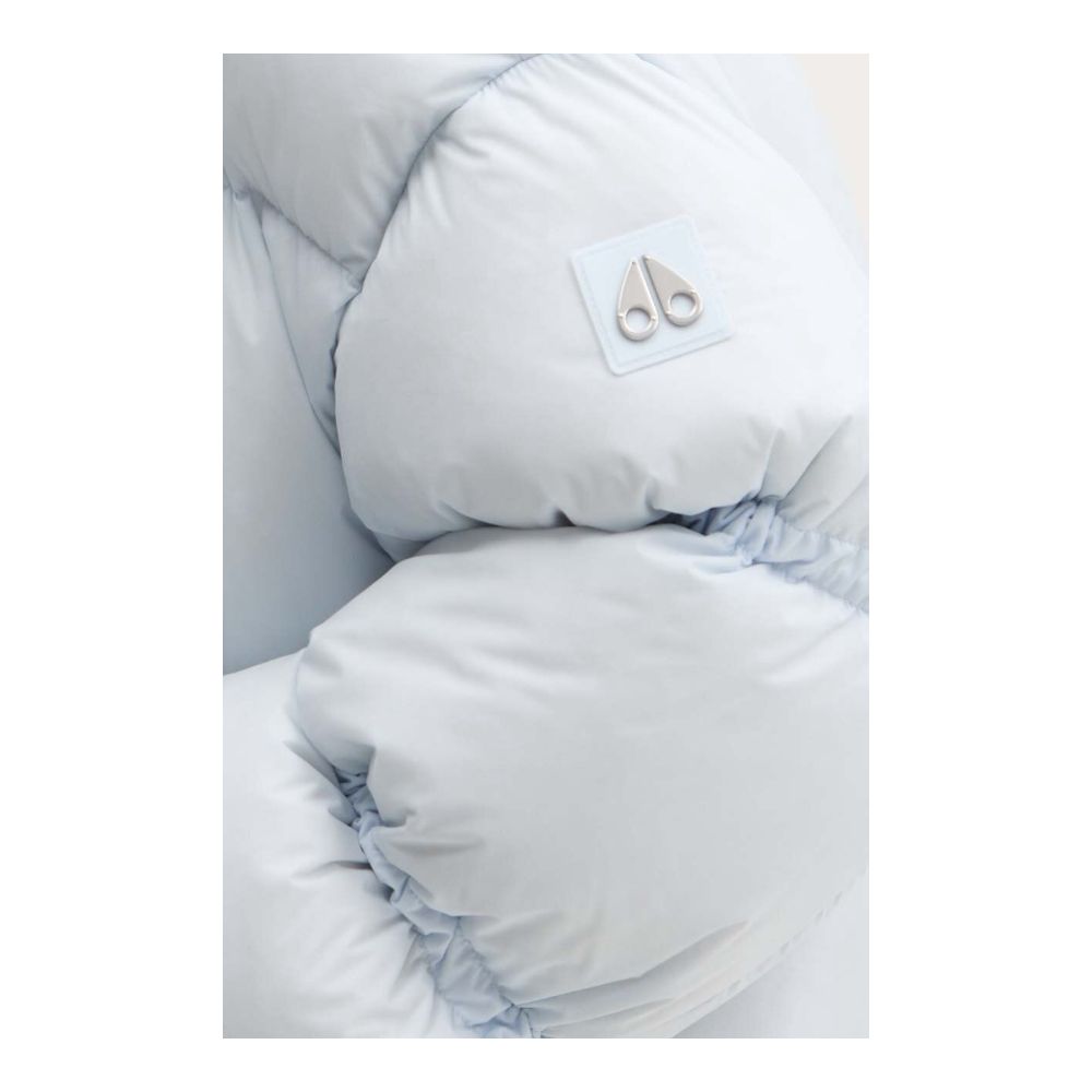 Close-up of Moose Knuckles Light Blue Nylon Women Jacket showcasing down padding and logo.