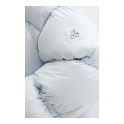 Close-up of Moose Knuckles Light Blue Nylon Women Jacket showcasing down padding and logo.