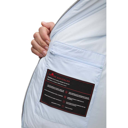 Interior label of Moose Knuckles Light Blue Nylon Women Jacket showcasing care instructions and pocket details.