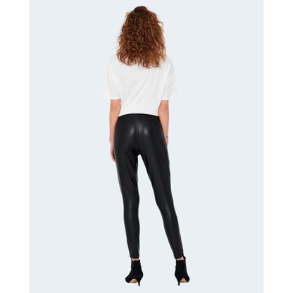 Back view of model wearing Only Black Polyester Leggings with glossy finish for stylish casual and evening occasions.