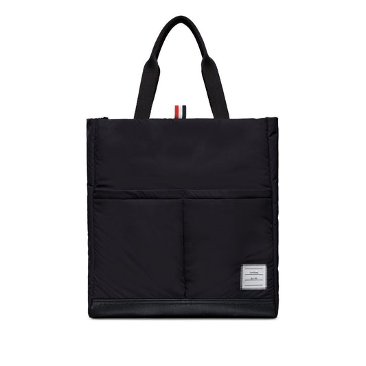 Thom Browne Multi pocket tote bag in black with two top handles, front patch pockets, and internal zip pocket, comes with dust bag.