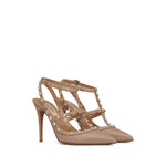 Valentino Garavani Rockstud Décolleté With 100mm Straps in powder pink calf leather with gold-tone detailing and pointed toe.