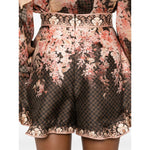 Zimmermann Illuminate Flutter Shorts with all-over floral print and ruffled trim, black concealed rear hook and zip.